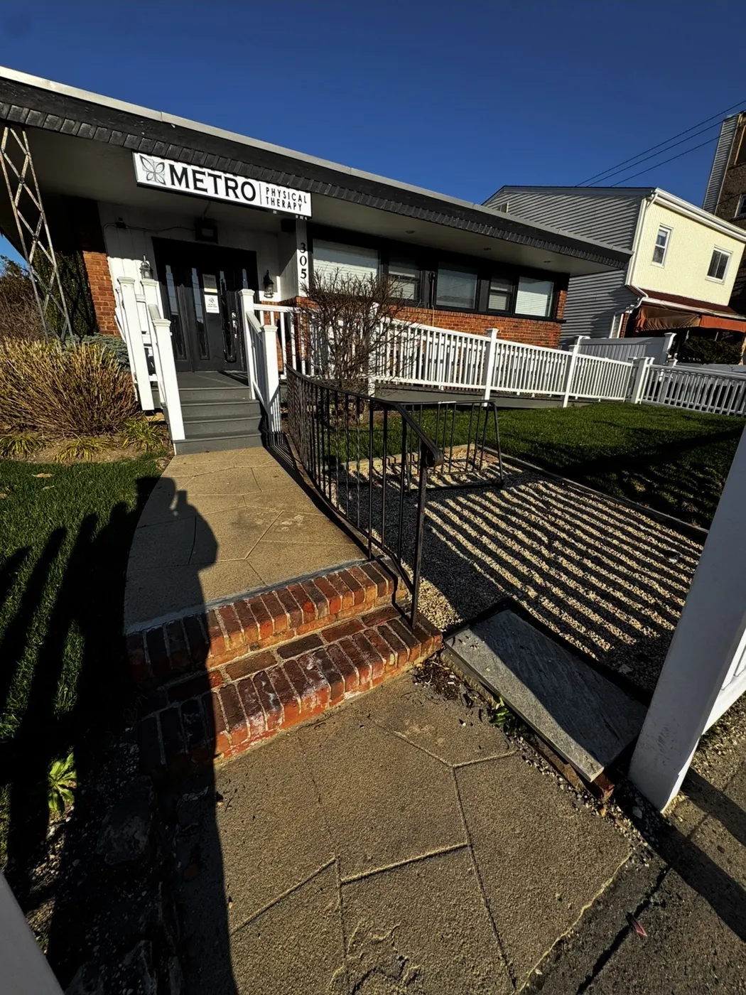 Before: cracked flagstone walkway and crumbling brick steps at a Long Island commercial office entrance